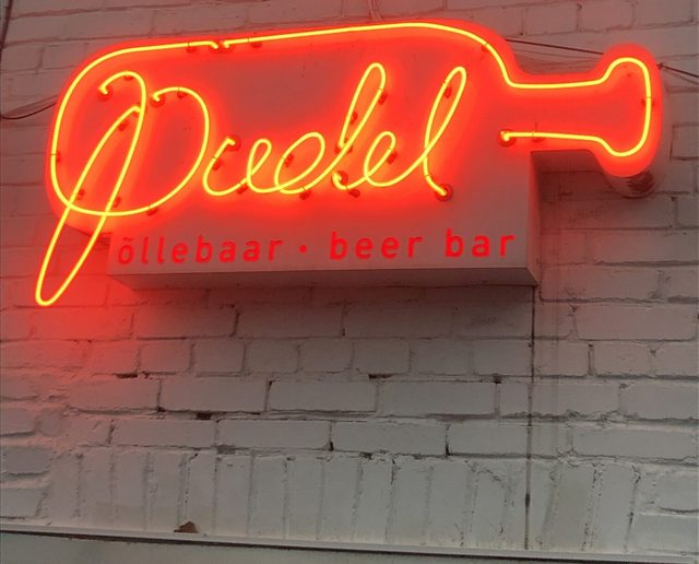 Red neon Pudel sign on brick wall